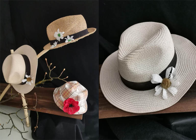 Bl&uuml;ten aus Papier an den Hut gesteckt